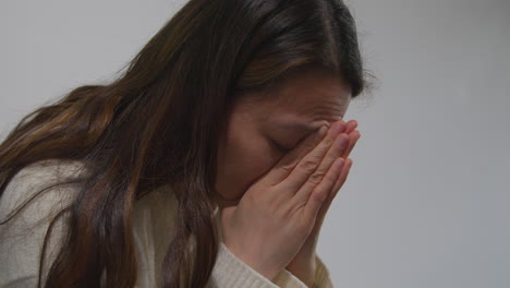 Close-Up-Of-Unhappy-Woman-Suffering-With-Depression-And-Anxiety-Sitting-In-Reception-Of-Doctor-Or-Mental-Health-Worker